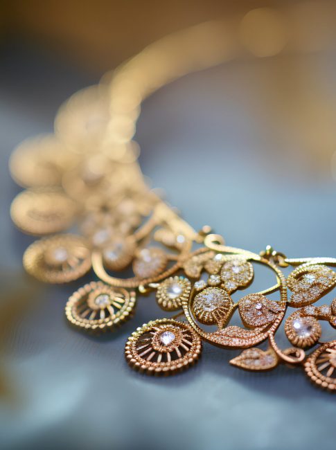 Beautiful gold jewelry on a dark background. Selective focus.